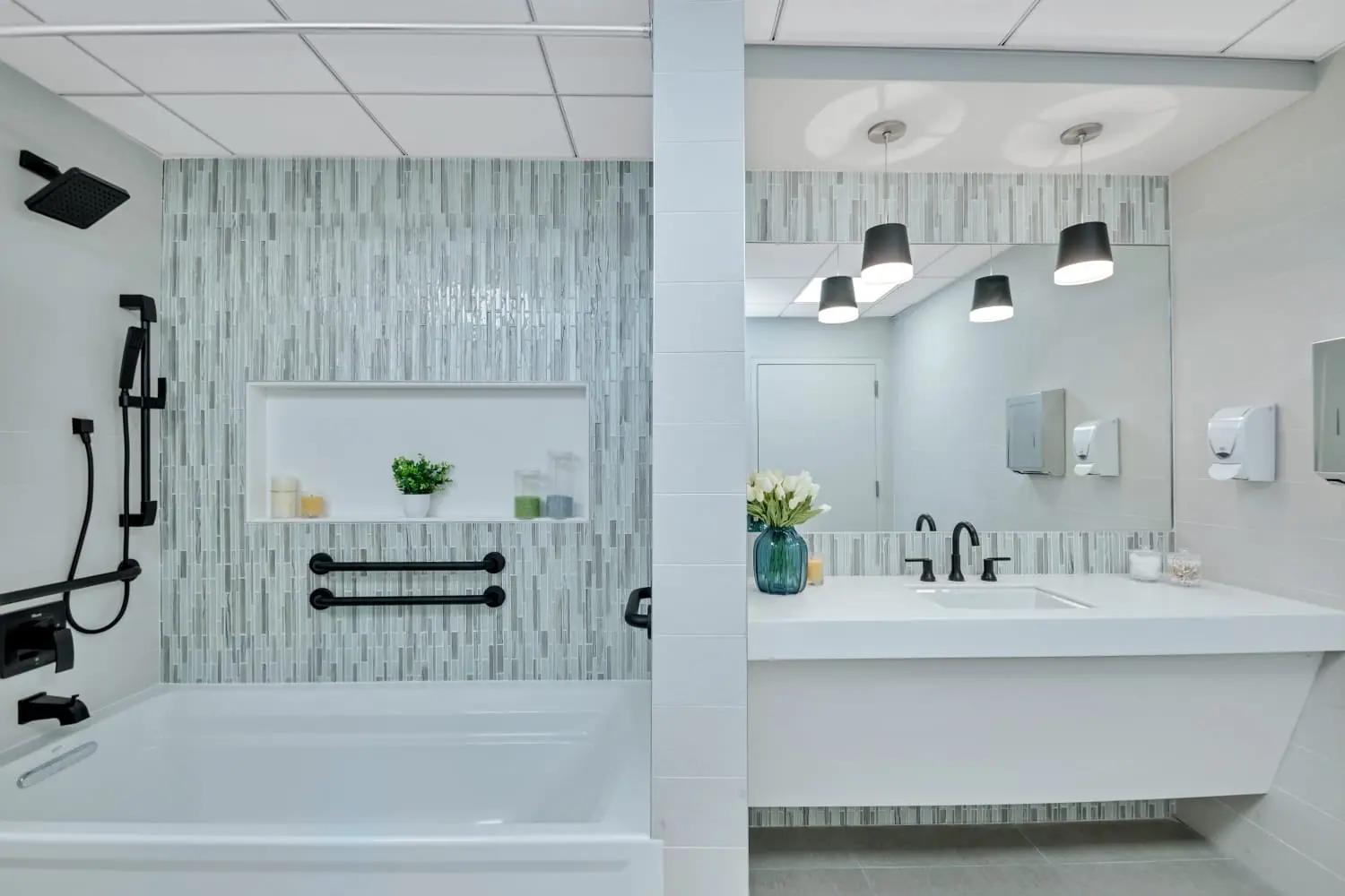 Accessible bathroom with grab bars, tub and open floating vanity