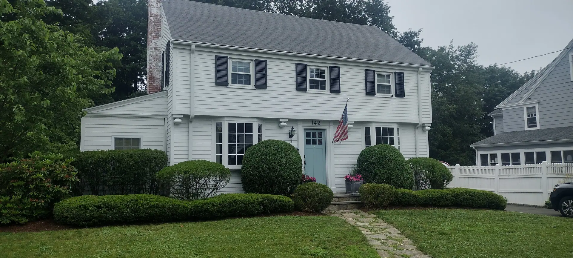 White colonial home after a full exterior repaint