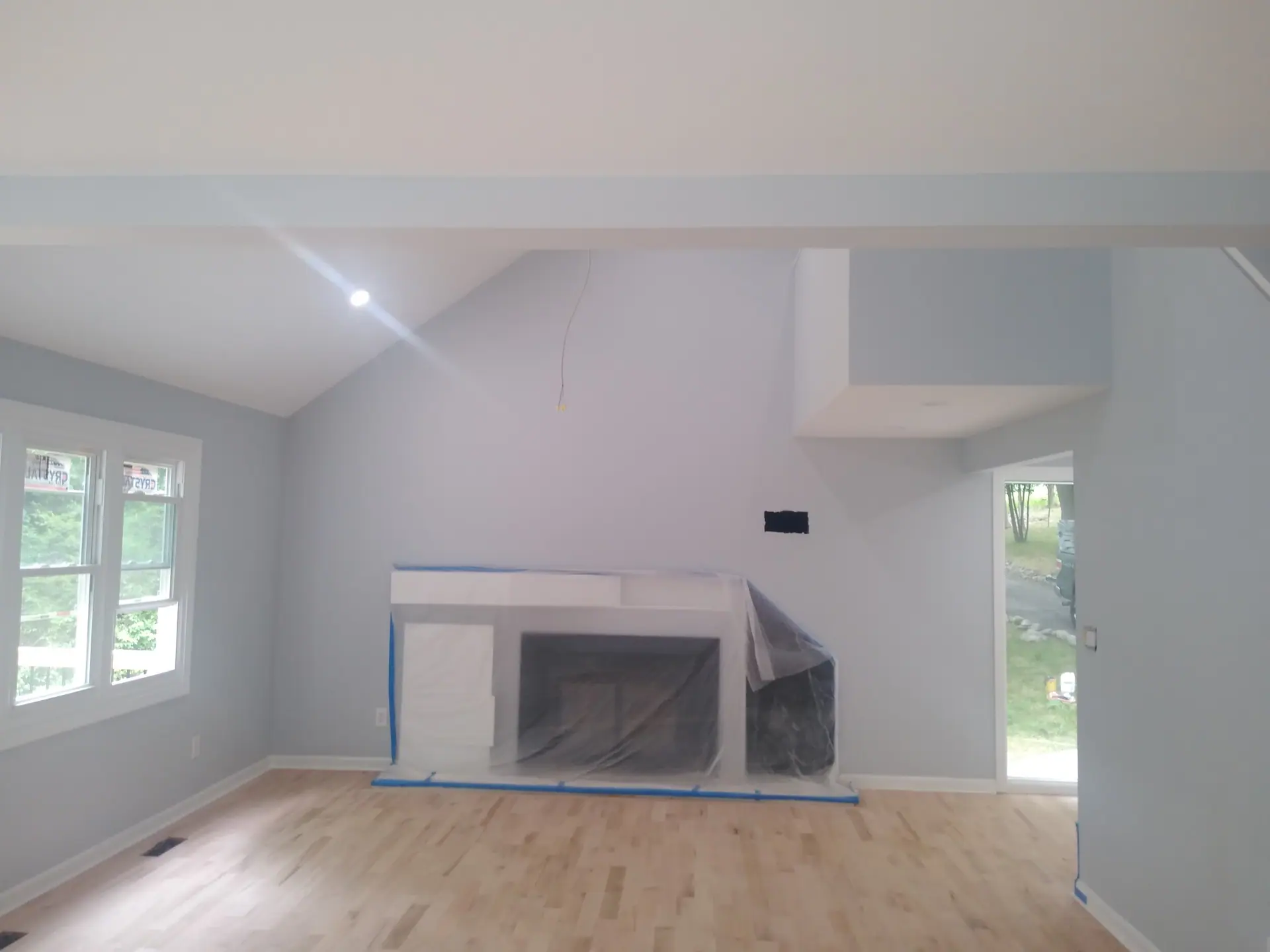 Living room mid-renovation with new hardwood floor