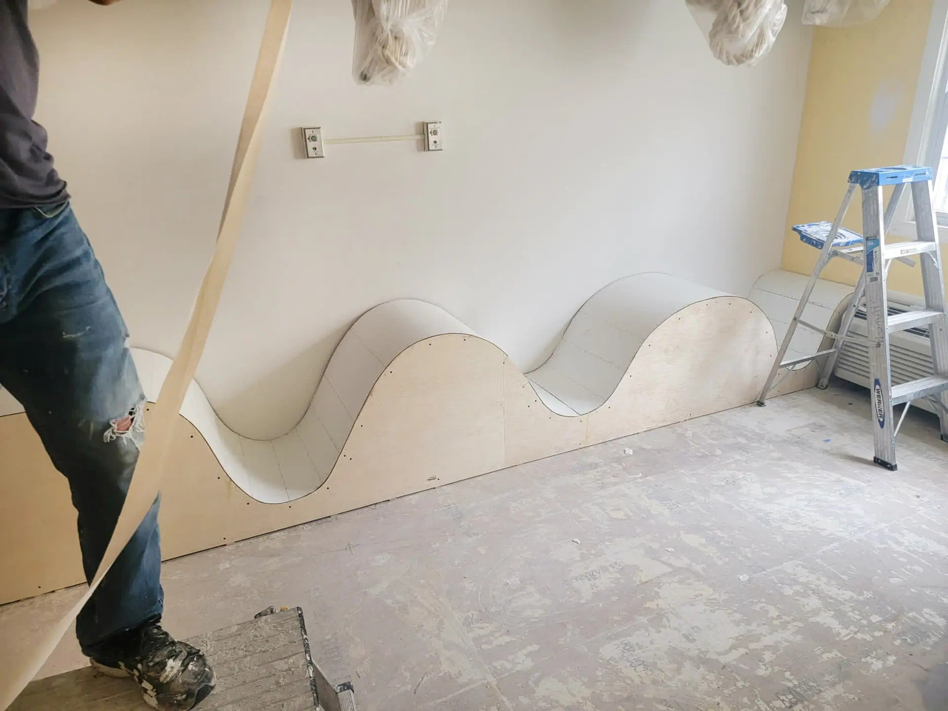 Curved wave-shaped wall being built